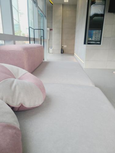 a hallway with a pink couch in a building at Elephant in Busan