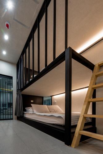 a bedroom with a bunk bed with a ladder at Elephant in Busan