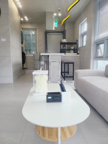 a living room with a white couch and a table at Elephant in Busan