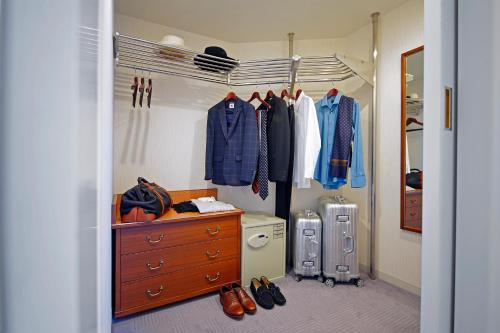 a walk in closet with a dresser and clothes at Imperial Hotel Tokyo in Tokyo