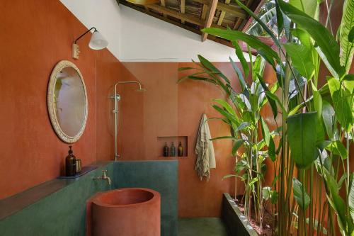 a bathroom with a tub and a sink with plants at Casa Tikiri - BOUTIQUE HOTEL Adults-Only in Ahangama