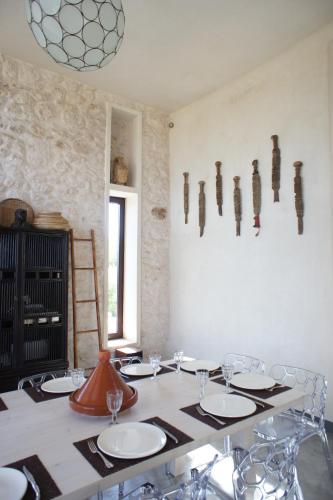 a dining room with a table with plates and glasses at Villa Azir in Ghazoua