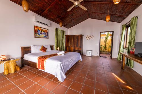 a bedroom with a bed and a television in it at Dugong Resort Phu Quoc in Phu Quoc