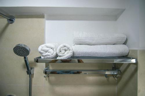 a towel rack with towels on it in a bathroom at Sandai Homes in Pātan