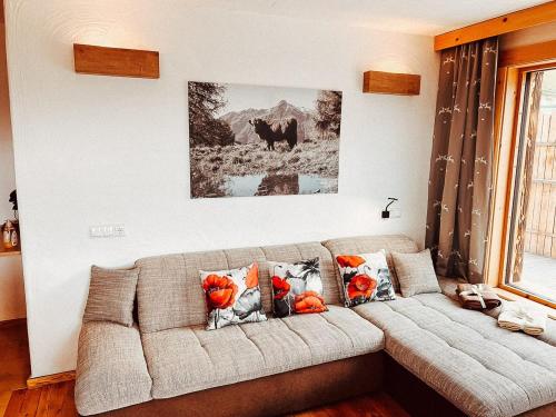 a living room with a couch with flowers on it at Zottlhoamat in Matrei in Osttirol