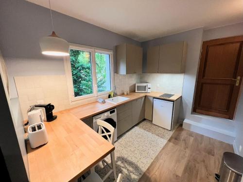 a kitchen with a table and a counter top at Pere Lachaise Apartments in Paris