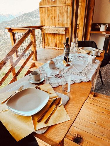 a table with a white plate on a wooden table at Zottlhoamat in Matrei in Osttirol