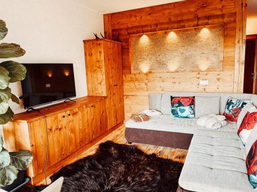a living room with a couch and a flat screen tv at Zottlhoamat in Matrei in Osttirol