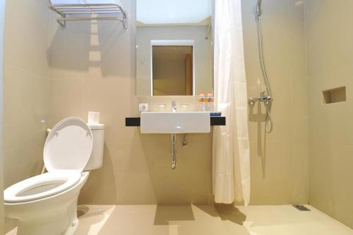 a bathroom with a toilet and a sink and a shower at Aveon Express Hotel by Daphna International in Yogyakarta