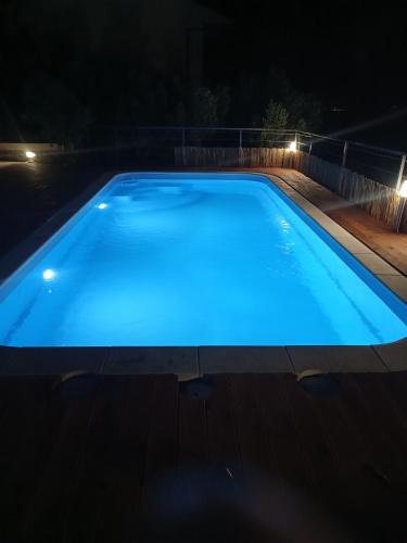 a swimming pool at night with blue lighting at Angeli Del Mare in Marusici 