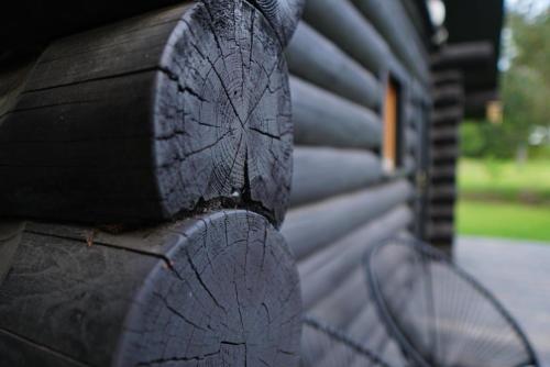 a close up of a tire on the side of a house at River House in Nītaure