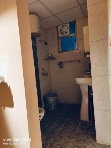 a bathroom with a toilet and a sink at RiShi in Lucknow