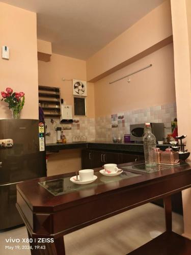 a kitchen with a table with two dishes on it at RiShi in Lucknow