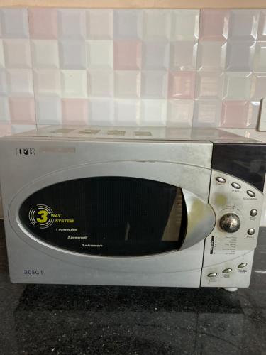 a microwave oven sitting on top of a counter at RiShi in Lucknow