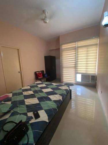 a bedroom with a bed and a window with blinds at RiShi in Lucknow