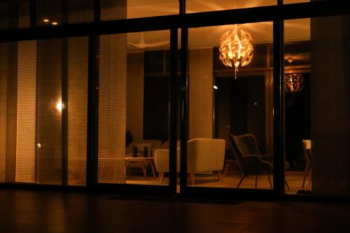 a room with a chandelier and a table and chairs at Hummingbird Beach House by EWA Properties in Manjeshwara