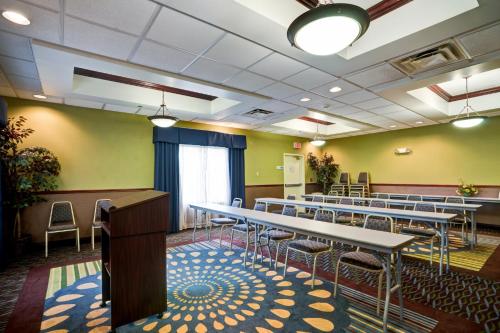 a room with rows of tables and chairs at Holiday Inn Express Hotel & Suites Christiansburg by IHG in Christiansburg