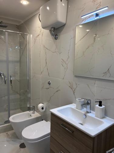 a bathroom with a sink and a toilet and a shower at Olina residence 2 in Naples