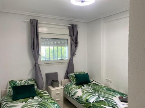 Postel nebo postele na pokoji v ubytování Apartment center of Albir 3D