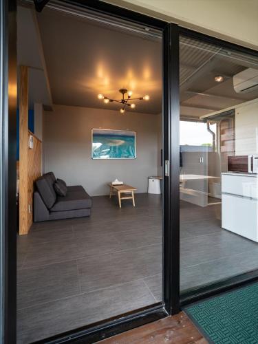 a living room with a couch and a table at Cottage Do in Nagura