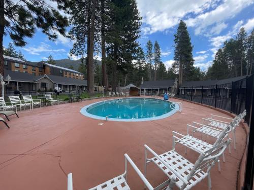 a swimming pool with lounge chairs around it at Tahoe Hacienda Inn in South Lake Tahoe