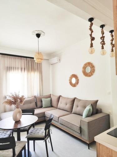 a living room with a couch and a table at Noelia House Ammouliani in Ammouliani