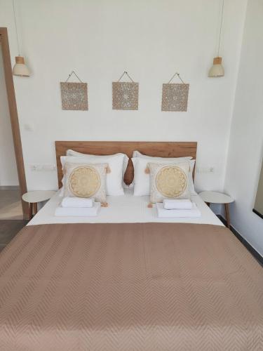 a bedroom with a large bed with two tables at Noelia House Ammouliani in Ammouliani