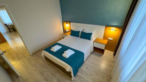a bedroom with a large bed with two pillows at La Bella Suit Otel in Kusadası