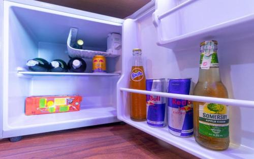 an open refrigerator filled with lots of drinks and condiments at Hotel Intourist Palace in Itahari