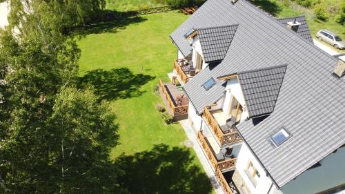 an aerial view of a house with a roof at Na Skraju Lasu e-apart in Jastrzębia Góra