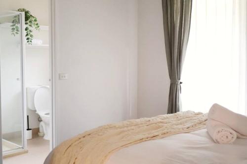 a white bedroom with a bed and a window at Badger Creek Hideaway in Badger Creek