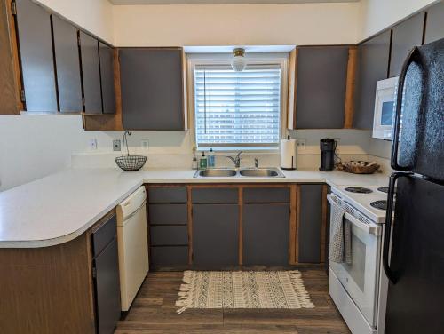 a small kitchen with a sink and a refrigerator at Your Home Away from Home in Payette