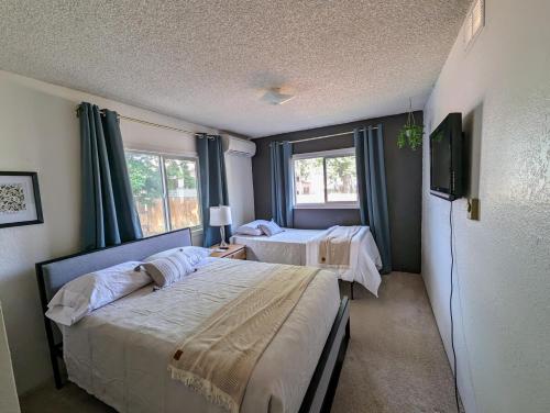 a bedroom with two beds and a television in it at Your Home Away from Home in Payette