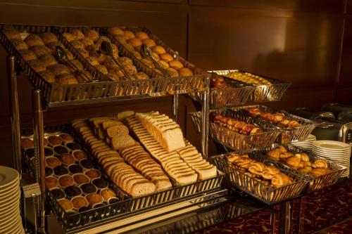 a bunch of trays filled with different types of pastries at Radisson Hotel President Old Town Istanbul in Istanbul