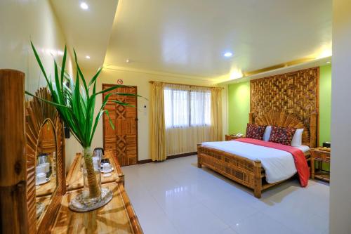 a bedroom with a bed in a room at Malapascua Exotic Island Dive Resort in Daanbantayan