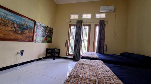 a bedroom with a bed and a window at Green ijen homestay and tour in Banyuwangi