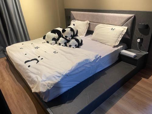 two stuffed panda bears sitting on a bed at IPOH TAMBUN THE COVE Your Ultimate Relaxation Getaway777 in Ipoh