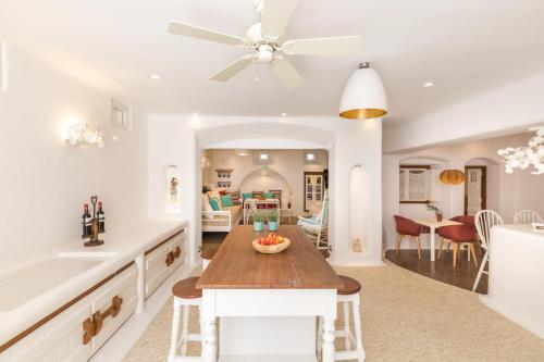 a kitchen and living room with a table and a dining room at Kallos Villas & Suites in Naxos Chora