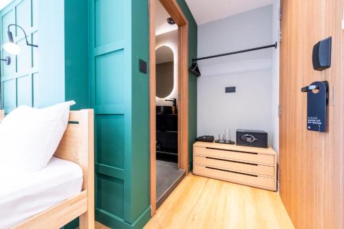 a bedroom with a green door and a bed at Habyt Cantonment - formerly Hmlet Cantonment in Singapore