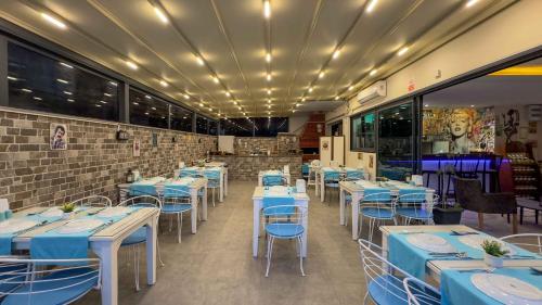 a dining room with blue tables and chairs at La Bella Suit Otel in Kusadası