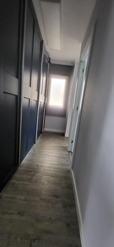 an empty hallway with a door and a window at Las Gaviotas in Viveiro