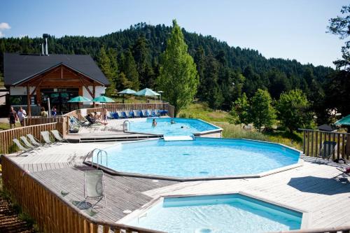 a group of three swimming pools in a resort at Huttopia Font Romeu in Font-Romeu