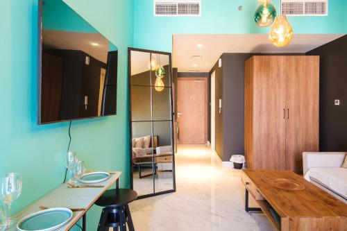 a living room with a table and a couch at Industrial Chic Retreat in Al Qurayyah