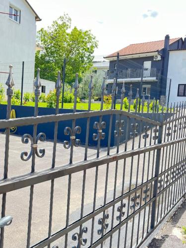 a fence in front of a building with flowers at Villa Erwin with heated pool in Imotski