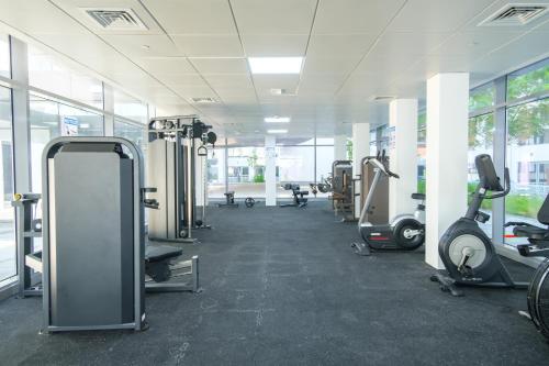 a gym with several treadmills and exercise bikes at Industrial Chic Retreat in Al Qurayyah