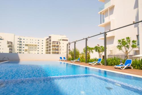 an image of a swimming pool in a building at Industrial Chic Retreat in Al Qurayyah