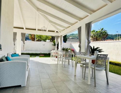 a patio with chairs and a table and a couch at InVilla Bed&Breakfast - Quality Rooms in Santa Maria di Castellabate
