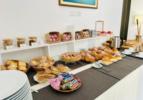 a table with various types of bread and pastries at InVilla Bed&Breakfast - Quality Rooms in Santa Maria di Castellabate