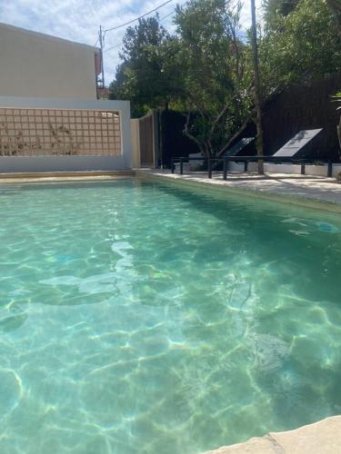 a large pool of blue water in a yard at Bond beach village in Altafulla