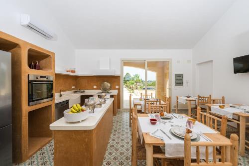 a kitchen and dining room with tables and chairs at LA LIMINI in Otranto